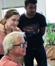 three people looking at a screen