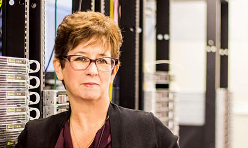 Terry Benzel in front of server racks