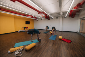 Yoga room with people practicing yoga