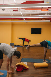 Yoga room with people practicing yoga